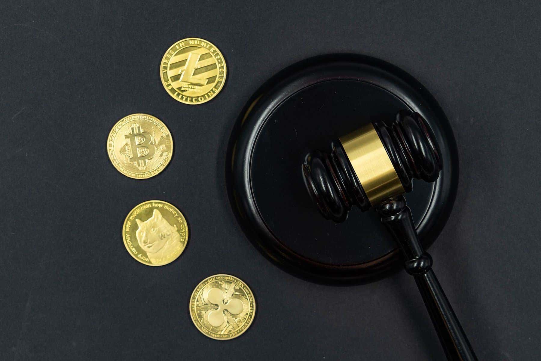 Gold crypto coins beside a judge's gavel