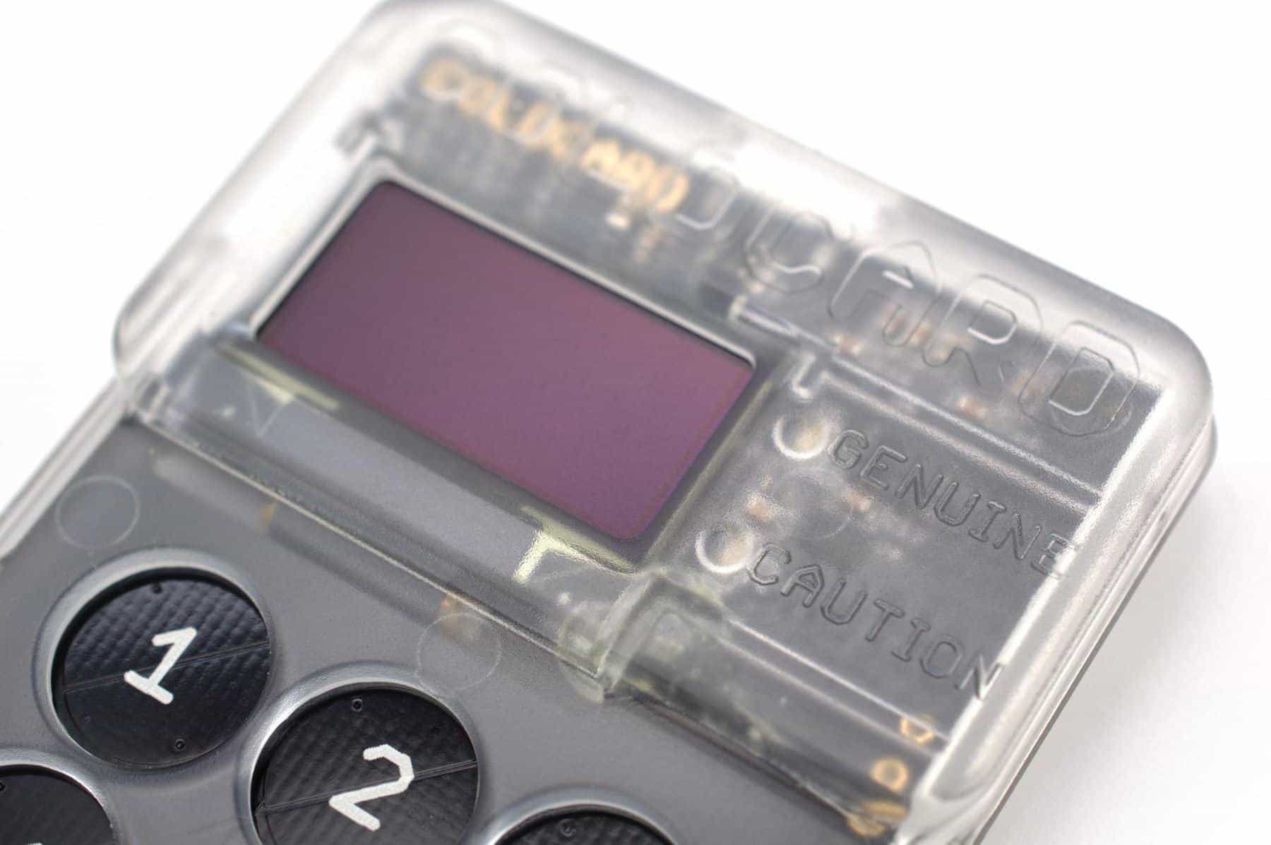 A small hardware crypto wallet device with a screen and keypad