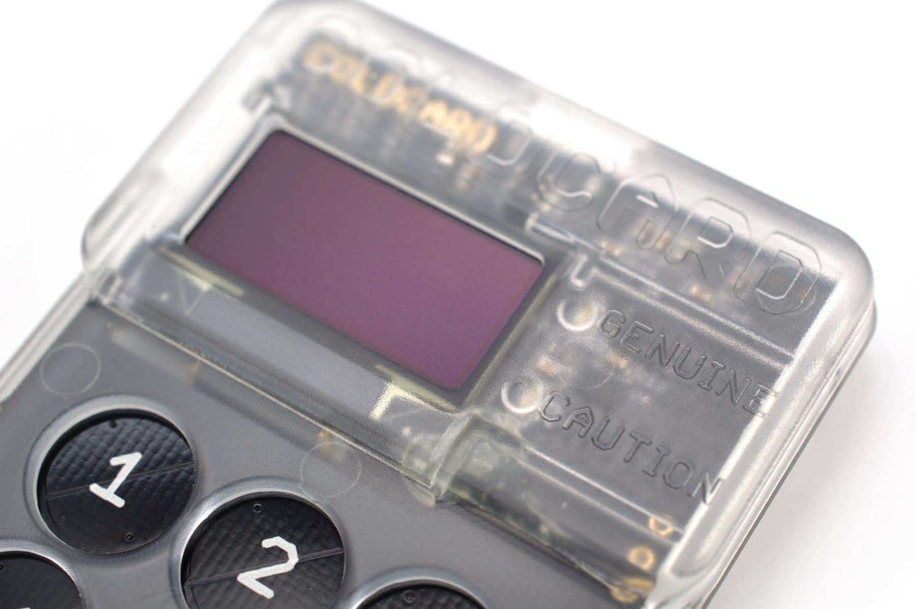 A small hardware crypto wallet device with a screen and keypad